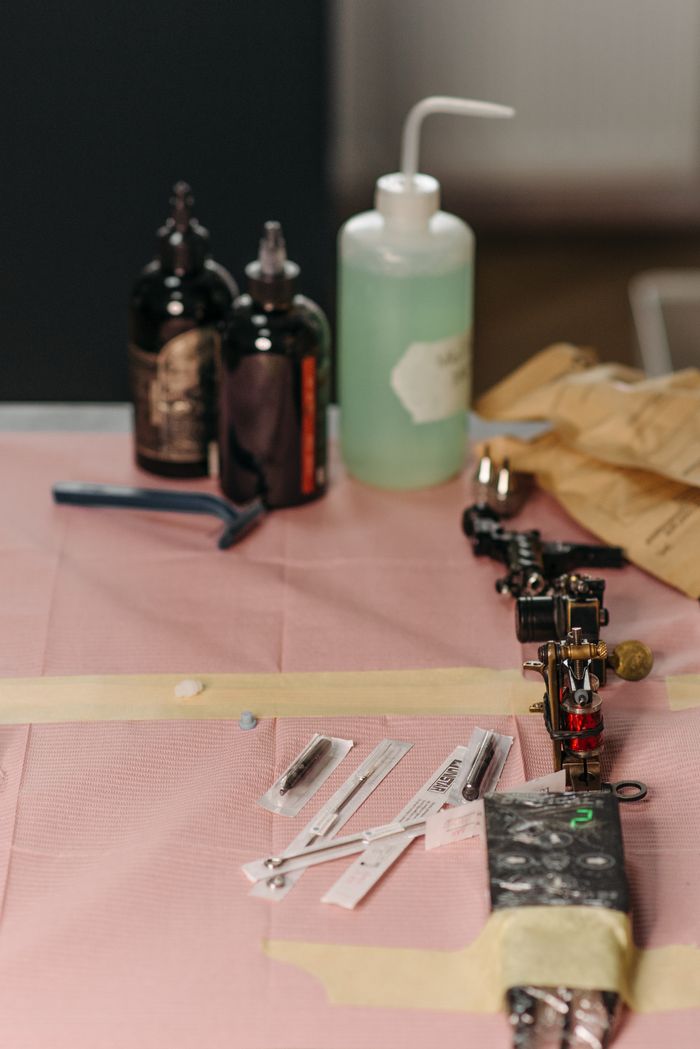 A collection of tattoo supplies on a studio table, ready for use.